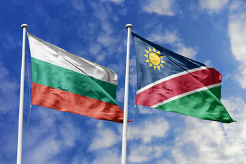 3D illustration. Bulgaria and Namibia Flag waving in the sky. High detailed waving flag. 3D render. Waving in the sky. Flags fluttered in the cloudy sky.