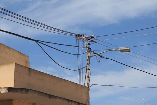 Messy electrical cables on wall corner in Malta