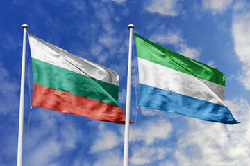 3D illustration. Bulgaria and Sierra Leone Flag waving in the sky. High detailed waving flag. 3D render. Waving in the sky. Flags fluttered in the cloudy sky.