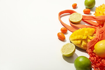Set of tropical fruit in bag on white background, space for text