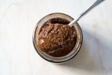 Granola Butter Spread on Bread or Ready to Eat with Spoon in Jar.
