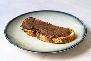 Granola Butter Spread on Bread or Ready to Eat with Spoon in Jar.
