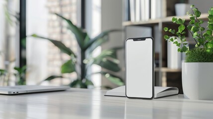 A white phone sits on a desk next to a potted plant. The phone is turned off and the screen is blank. The scene is simple and minimalistic, with the focus on the phone and the plant