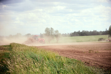 Fototapeta premium tractor to the field plowing the land