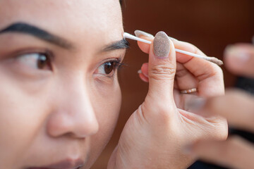 Eyebrow grooming with cotton swab