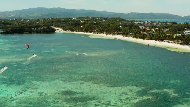 Kitesurfers enjoying wind power on Bulabog beach, top view. Kitesurfing on a tropical island. Boracay, Philippines