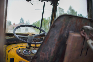 An old farm tractor. View of headlights, engine and cabin