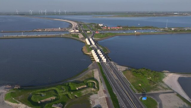 Afsluitdijk construction on pumping stations, new sluices and A7 Highway in Northern Netherlands. Long Road in the Sea.