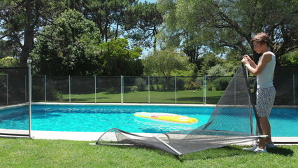 Child removing swimming pool with safety fence