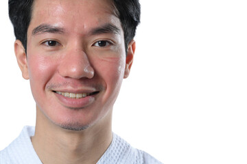Obraz premium Smiling man after facial laser treatment on white background. Aesthetic face treatment concept