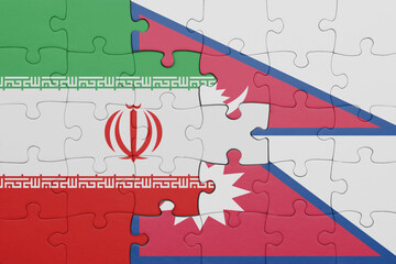 puzzle with the colourful national flag of nepal and flag of iran .