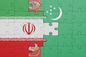 puzzle with the colourful national flag of turkmenistan and flag of iran .