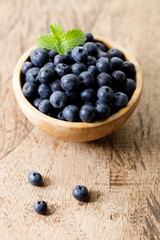 Ripe organic blueberries on wooden table background. Selective focus.