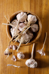 Ripe organic garlic clove and bulb on wooden background.  Close-up. Selective focus.