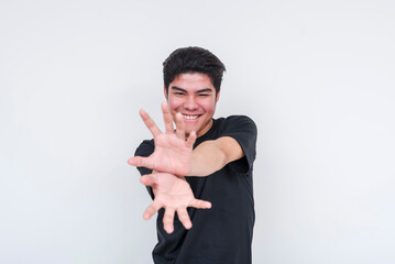Young Asian man pretending to make an anime kamehameha blast