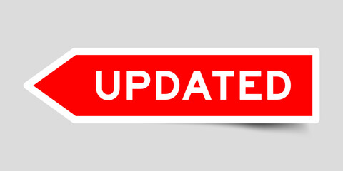 Red color arrow shape sticker label with word updated on gray background