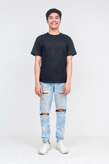 Obraz premium Young man in black shirt and ripped jeans smiling