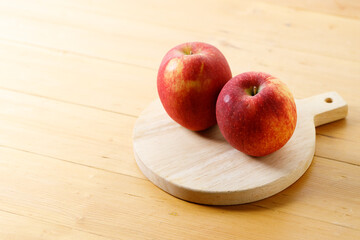 Ripe organic red apple on wooden table background.