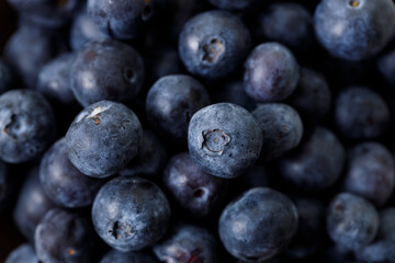 Ripe organic blueberries on white wooden table background. Selective focus.