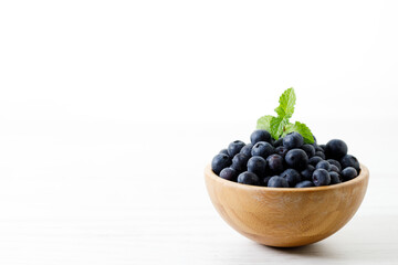 Ripe organic blueberries on white wooden table background. Selective focus.