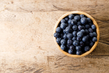 Ripe organic blueberries on wooden table background. Selective focus.