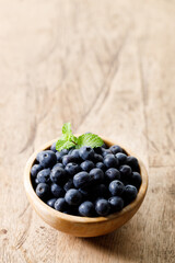 Ripe organic blueberries on wooden table background. Selective focus.