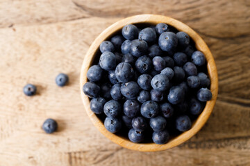 Ripe organic blueberries on wooden table background. Selective focus.
