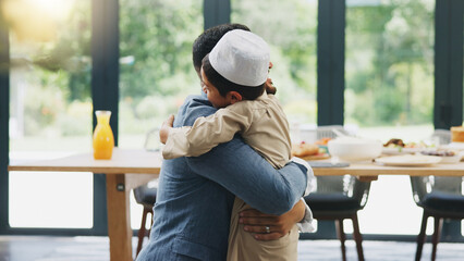 Muslim, father and son with hug at home for hello, reunion and bonding together before dinner. Family, dad and child or boy with embrace for welcome gesture, greeting and support with care in house © AchillesReel/peopleimages.com