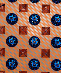 Repetitive flat lay of rows of blue and orange metal sphere shapes on a vibrant orange mesh background concept 3d render