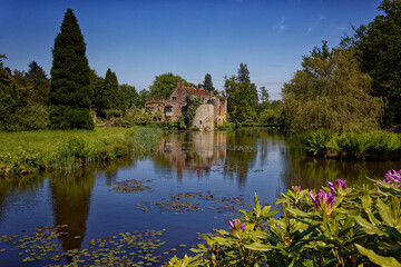 Reflections of the folly in the moat of Old Scotney Castle Lamberhurst Kent UK
