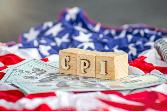CPI, consumer price index symbol. Wooden blocks with words CPI, consumer price index on dollar bills with a calculator, coins. Business and CPI, Business and consumer price index concept.