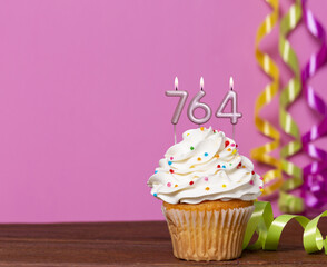 Birthday Cupcake With Candles Lit Forming The Number 764