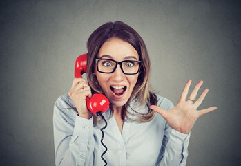 Thrilled young woman winning on the telephone