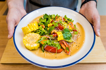 Spicy glass noodle salad on the white plate