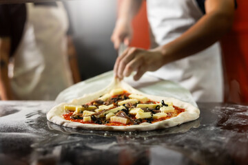 experienced chef - process of making pizza. Professional chef prepares the dough with flour to make pizza or pasta Italian food