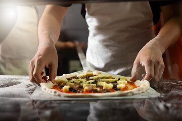 experienced chef - process of making pizza. Professional chef prepares the dough with flour to make pizza or pasta Italian food