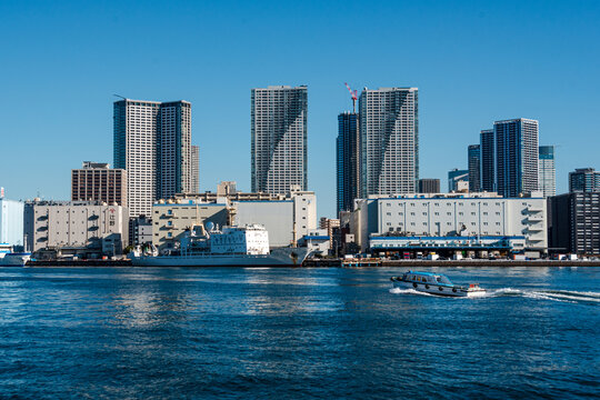Motorboat in front of skyscrapers of Tokyo Skyline, waterfront in Habor of Harumi district, Tokyo, Honshu