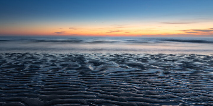 Sunset and sand ripples at Watergate Bay in Cornwall, England, United Kingdom