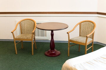Fototapeta premium Small cramped hotel room with old furniture.