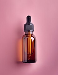 Brown Dropper Bottle on Pink Isolated Surface