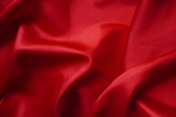 Texture red satin or silk is beautiful and luxurious (blurred)