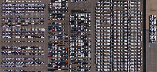 Top view of the electric vehicle transport yard and intercontinental shipping industry.	