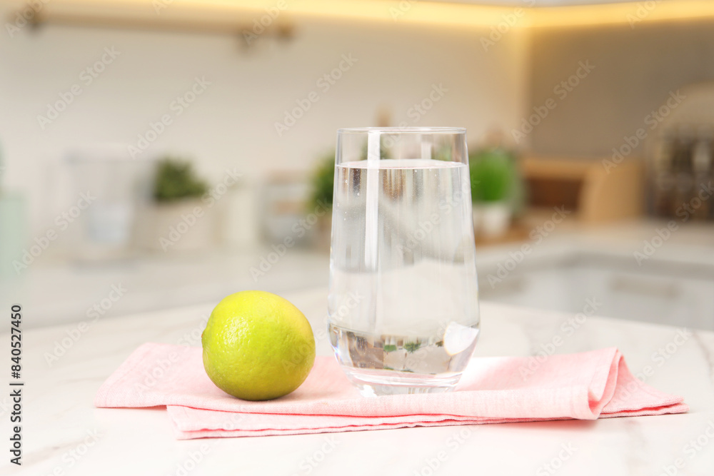 Canvas Prints Filtered water in glass and lime on white marble table in kitchen, closeup