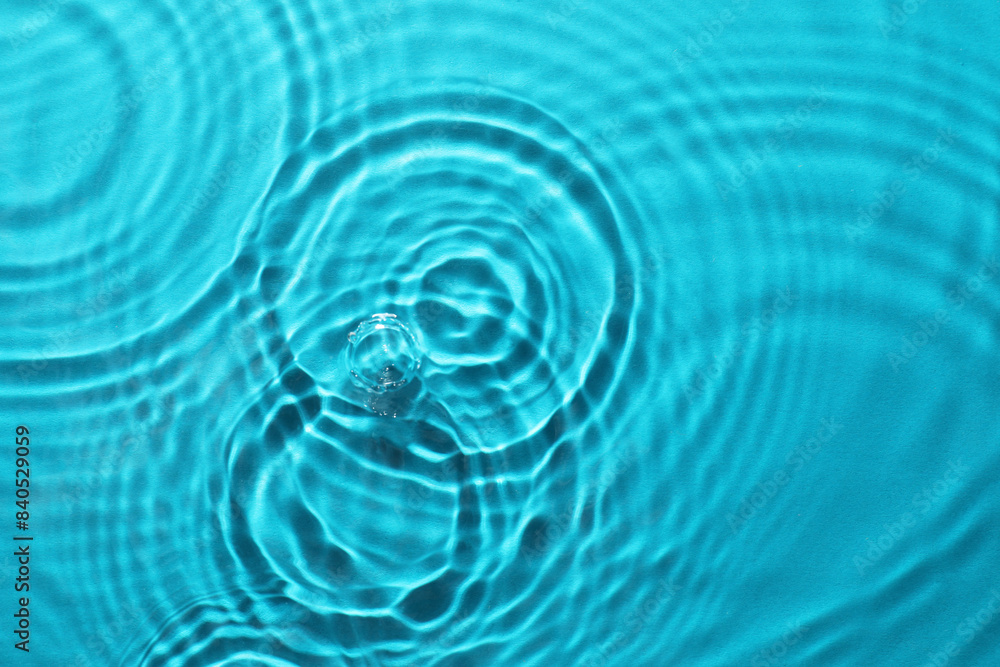 Poster Rippled surface of clear water on light blue background, top view