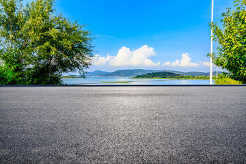 Asphalt road and beautiful nature landscape by the lake