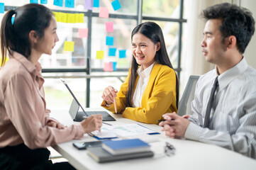 Three people are sitting at a table, two of them are women and one is a man