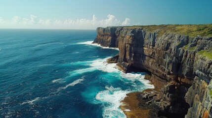 Aerial view of dramatic coastal cliffs with crashing waves