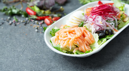Raw salmon salad with vegetables on a plate
