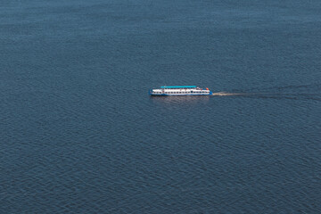 Passenger white ship sailing on the river in the summer. View from Camel Mountain, Zhiguli rocks, Samarskaya Luka Nature Reserve on the Volga River.