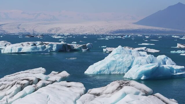 Aerial view of the big pieces of ice from glacier, ice islands, glacier and mountains, J&ouml;kuls&aacute;rl&oacute;n - Glacier Lagoon. A large glacial lake in southern part of Vatnaj&ouml;kull National Park, Iceland